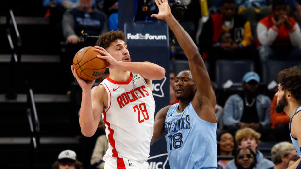 Dec 15, 2023; Memphis, Tennessee, USA; Houston Rockets center Alperen Sengun (28) passes the ball as Memphis Grizzlies center Bismack Biyombo (18) defends during the first half at FedExForum. 